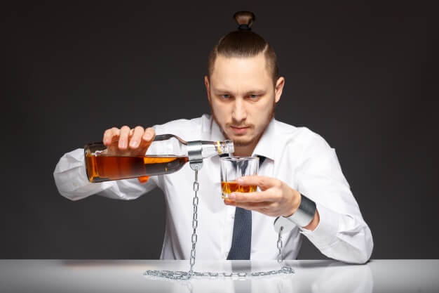 Alcohol addict pouring whiskey